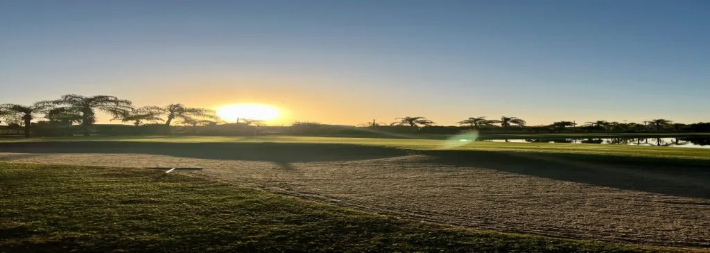 view of golf course sand trap at sunset